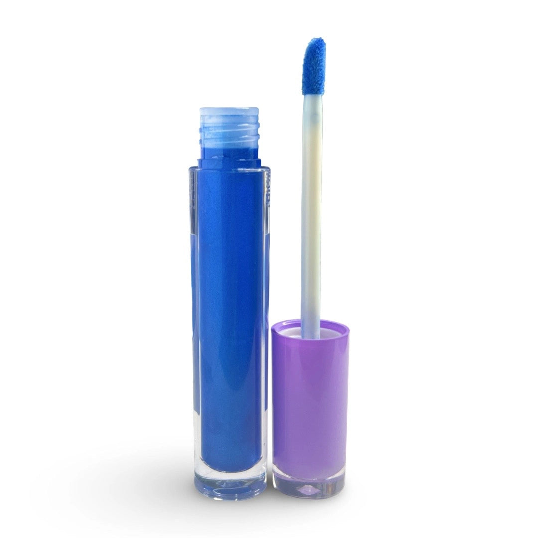 A tube of vibrant blue liquid lip color shown open with its applicator wand resting beside it. The tube is filled with bright blue product, and the cap is a light purple/lavender color, set against a plain white background.