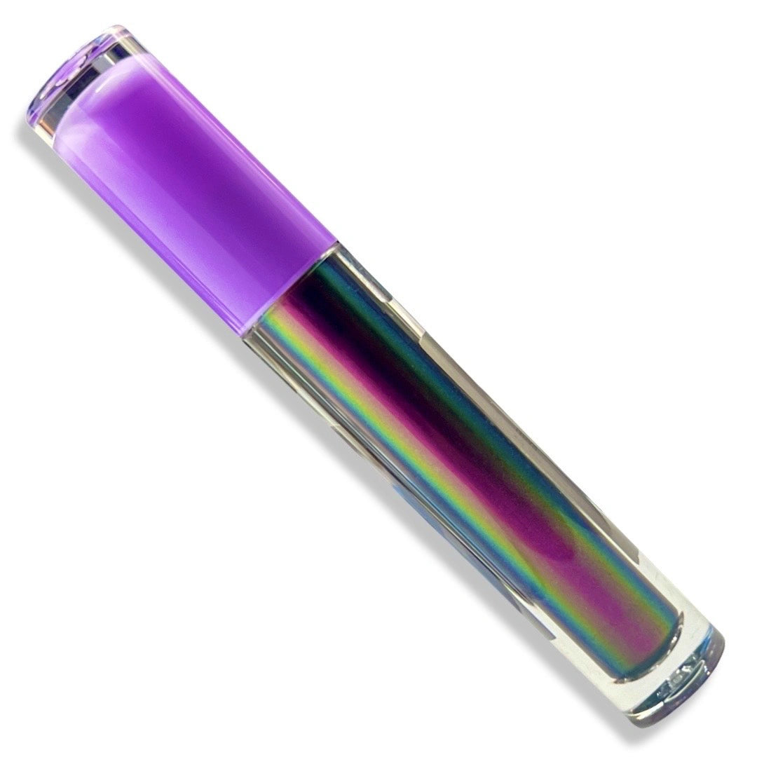 A clear cylindrical cosmetic tube with a translucent purple cap, filled with an iridescent rainbow liquid showing purple, green, blue, and pink tones, photographed on a white background.