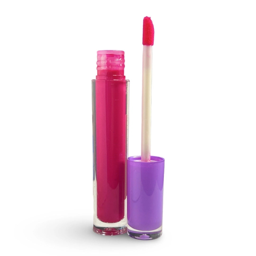A clear cylindrical lip gloss tube filled with bright magenta pink gloss, shown open with the cap beside it on a white background. The cap is filled with a purple material and the applicator wand has a pink tip.