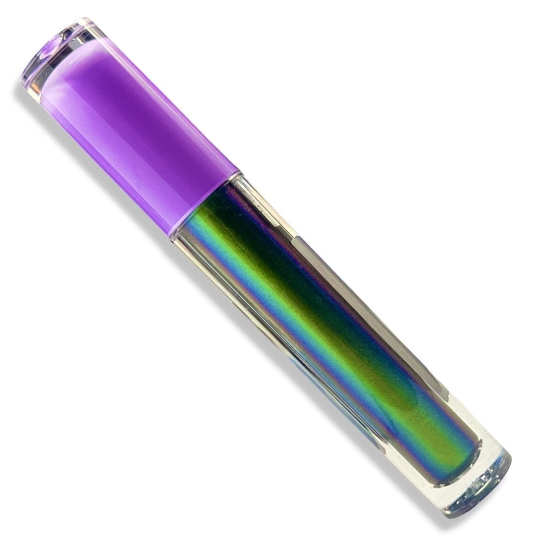 A clear cylindrical cosmetic tube containing an iridescent holographic lip gloss that shifts between green, blue, and purple, with a solid purple cap, shown on a white background.