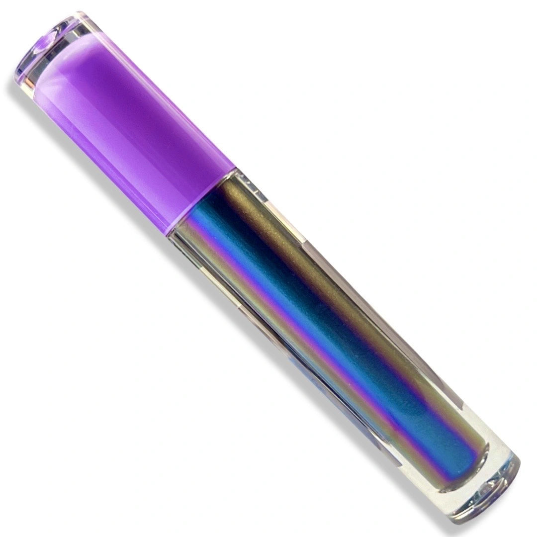 A clear cylindrical cosmetic tube with a translucent purple cap, showing an iridescent holographic liquid inside that shifts between blue, purple, and gold. The product is photographed diagonally on a clean white background.