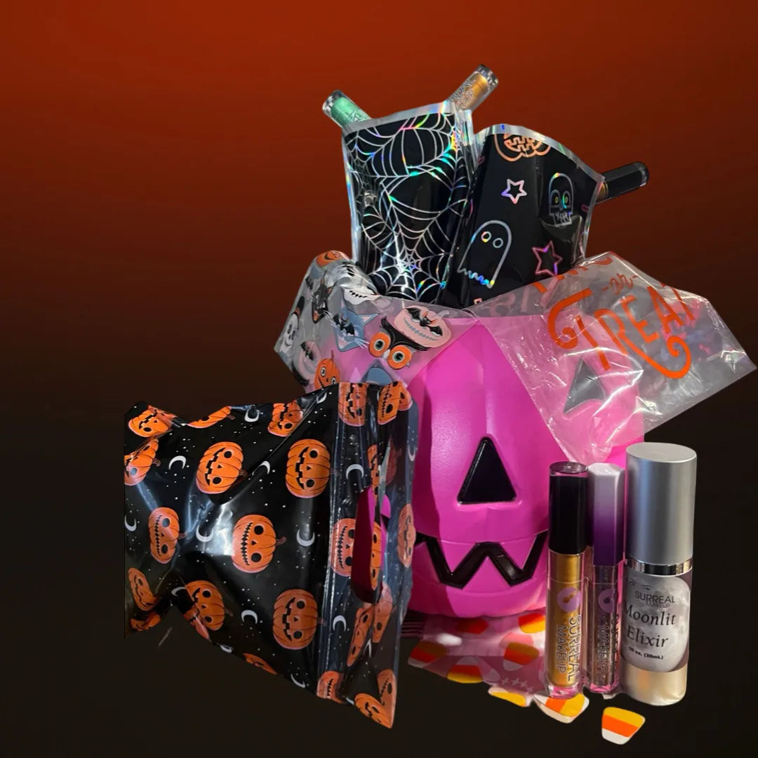 A Halloween-themed beauty gift set featuring a pink jack-o'-lantern bucket, black and orange pumpkin-patterned pouches, a spiderweb pouch, a small black ghost bag, and two cosmetic bottles on a dark gradient background.